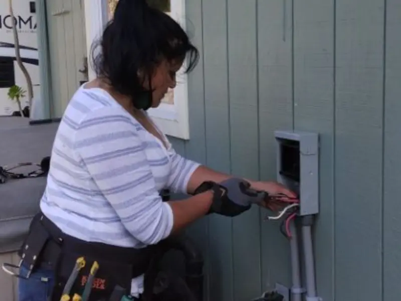Licensed electrician wiring an exterior subpanel in Patterson